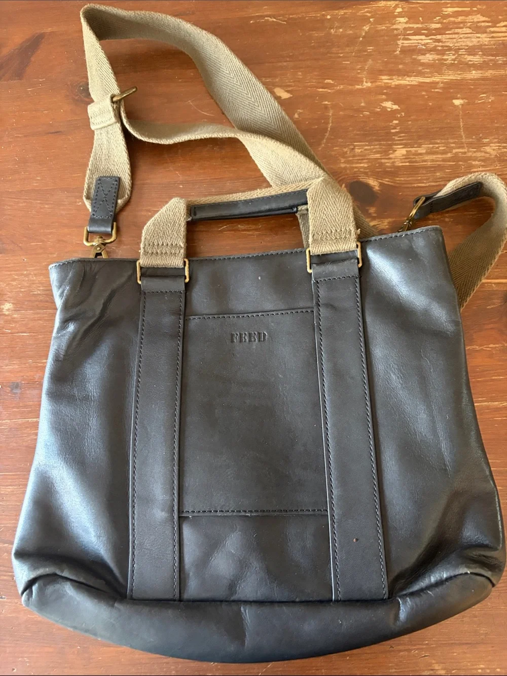FEED Black Leather Messenger Bag with Brown Strap Web Adjustable Strap